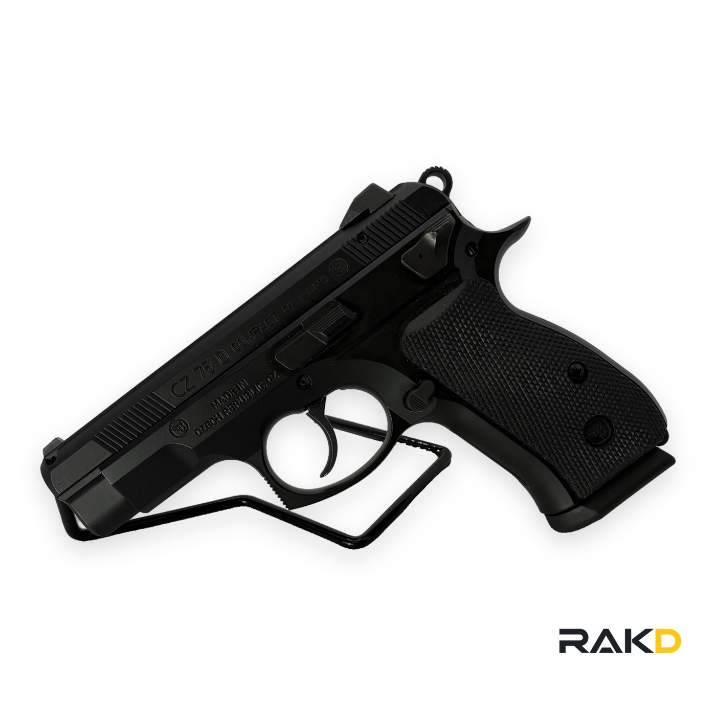 A black CZ 75 D Compact pistol on a wire stand, the slide marked CZ 75 D Compact, cal. 9 Luger, made in Czech Republic.